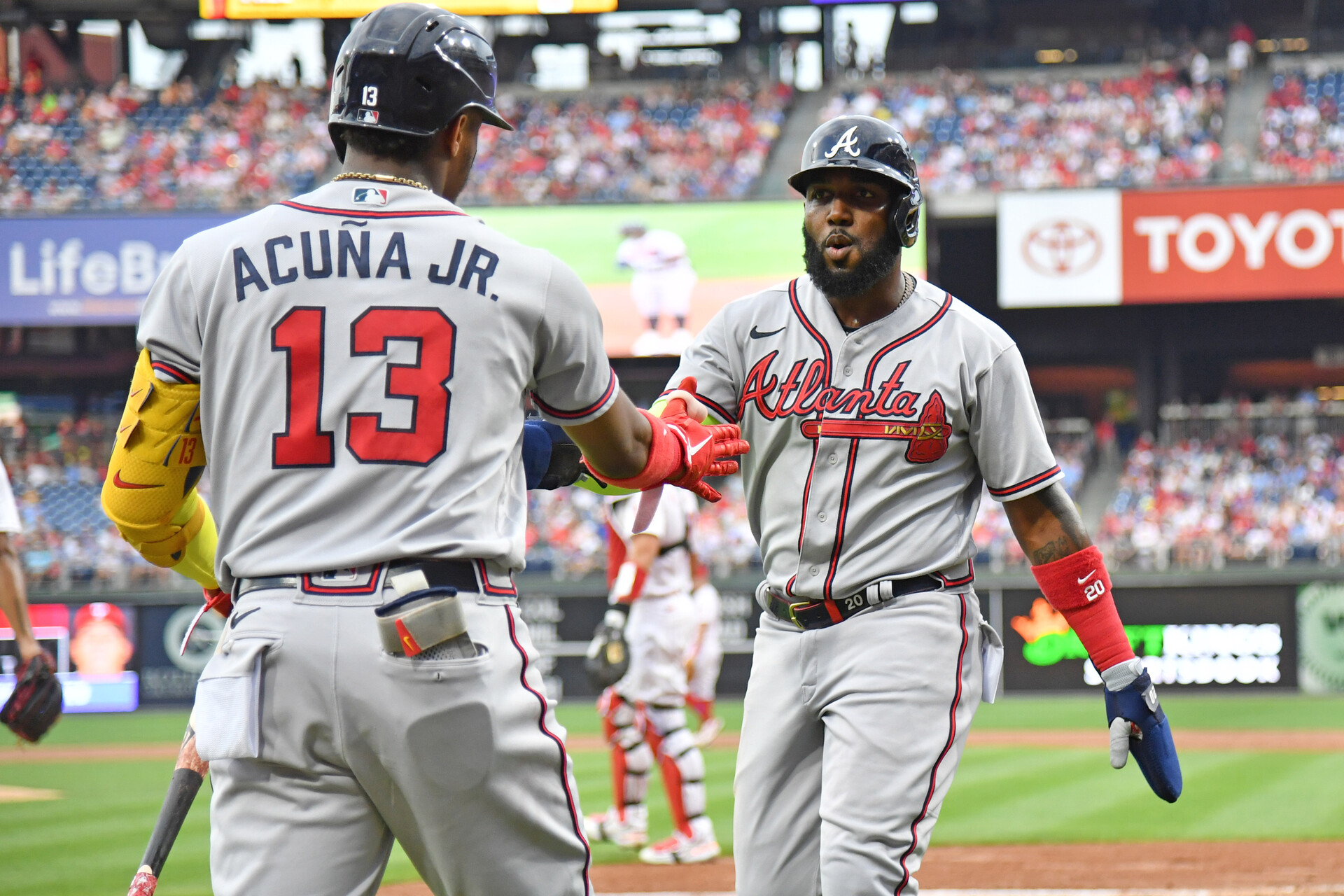 Jul 25, 2022; Philadelphia, Pennsylvania, USA; Atlanta Braves designated hitter Marcell Ozuna (20) celebrates with right fielder Ronald Acuna Jr. (13) after scoring against the Philadelphia Phillies during the second inning at Citizens Bank Park.
