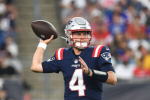 New England Patriots quarterback Bailey Zappe (4) looks to throw the ball against the New York Giants during the first half at Gillette Stadium.