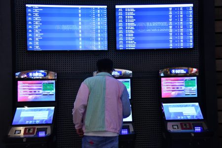 A customer purchase a ticket from a betting kiosk at Barstool Sportsbook in Ameristar Black Hawk in Black Hawk, Colorado on Friday, April 30, 2021.
