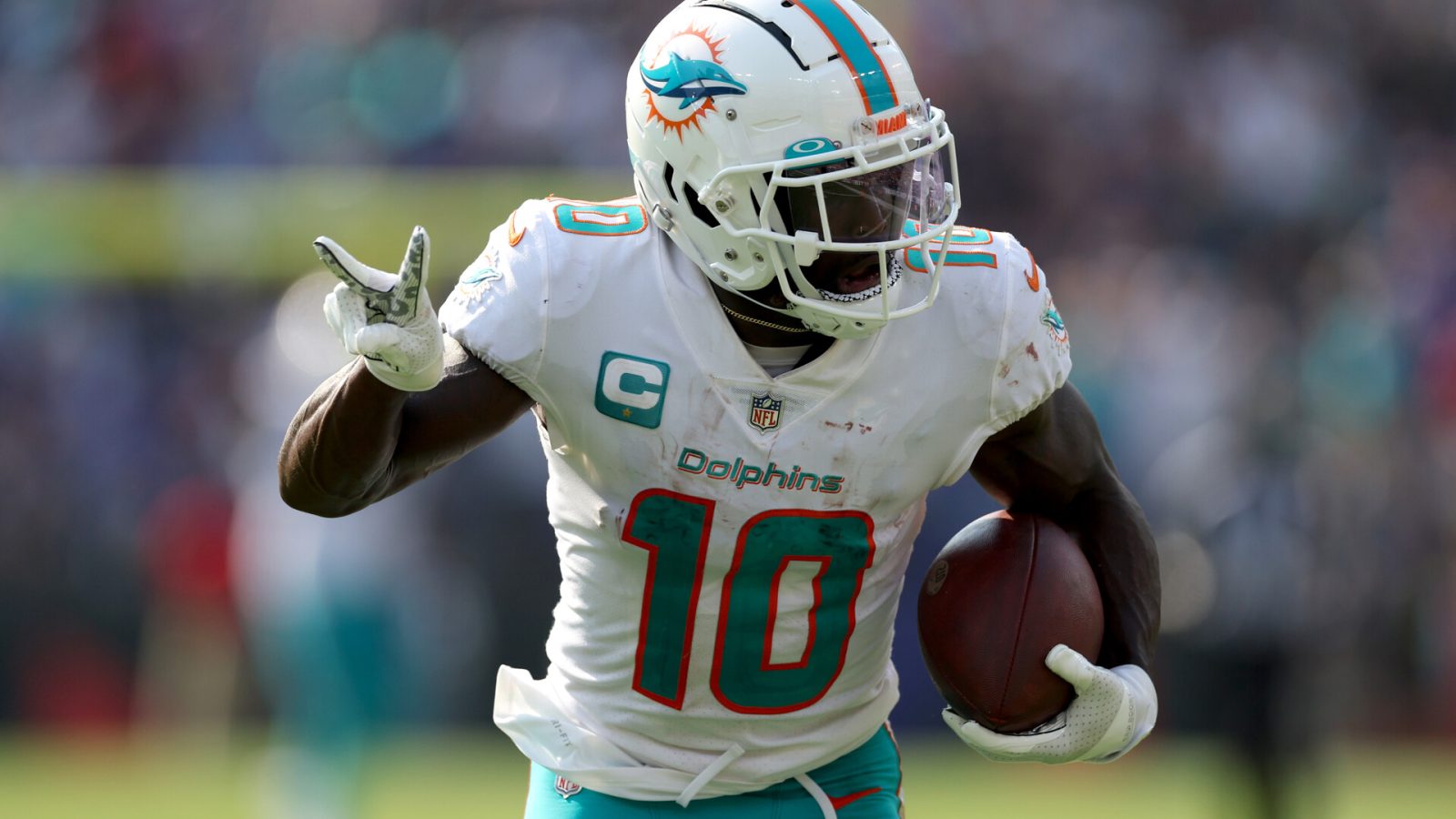 Wide receiver Tyreek Hill #10 of the Miami Dolphins celebrates while scoring his second pass touchdown against the Baltimore Ravens at M&T Bank Stadium on September 18, 2022 in Baltimore, Maryland.