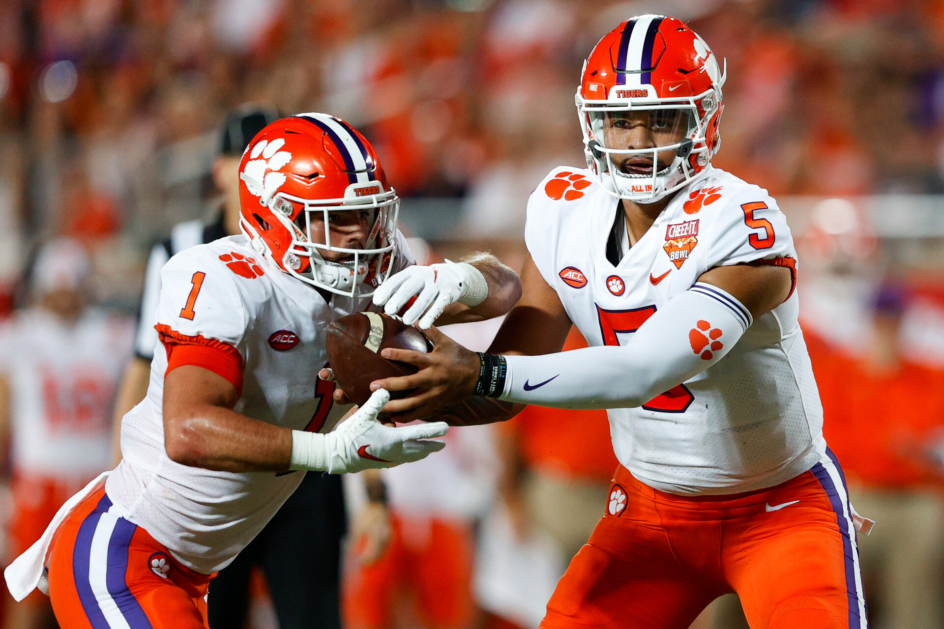 Clemson Tigers quarterback D.J. Uiagalelei (5) hands the ball off to running back Will Shipley (1) in the first half against the Iowa State Cyclones at Camping World Stadium