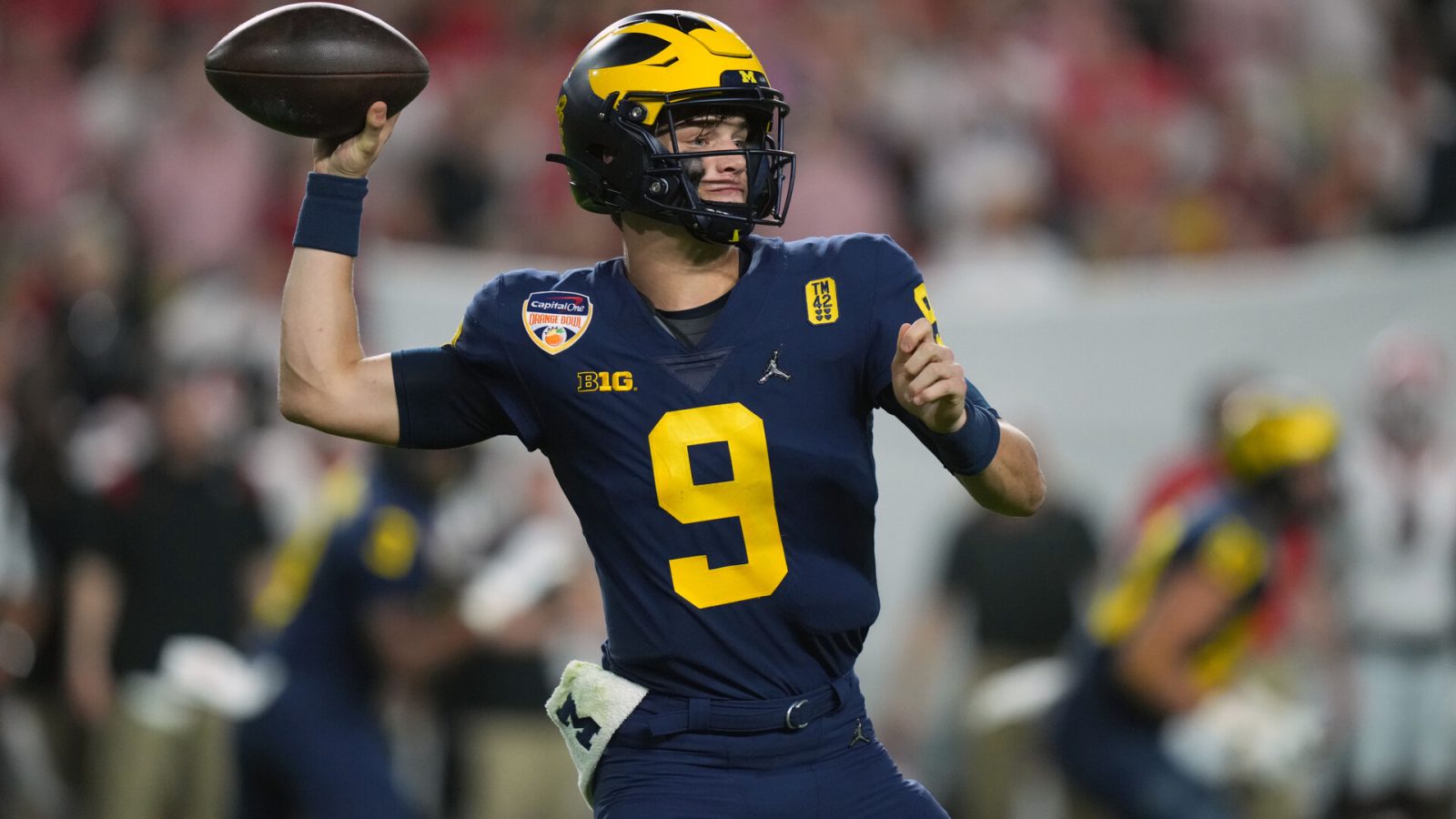 Dec 31, 2021; Miami Gardens, FL, USA; Michigan Wolverines quarterback J.J. McCarthy (9) throws against the Georgia Bulldogs during the fourth quarter in the Orange Bowl college football CFP national semifinal game at Hard Rock Stadium.