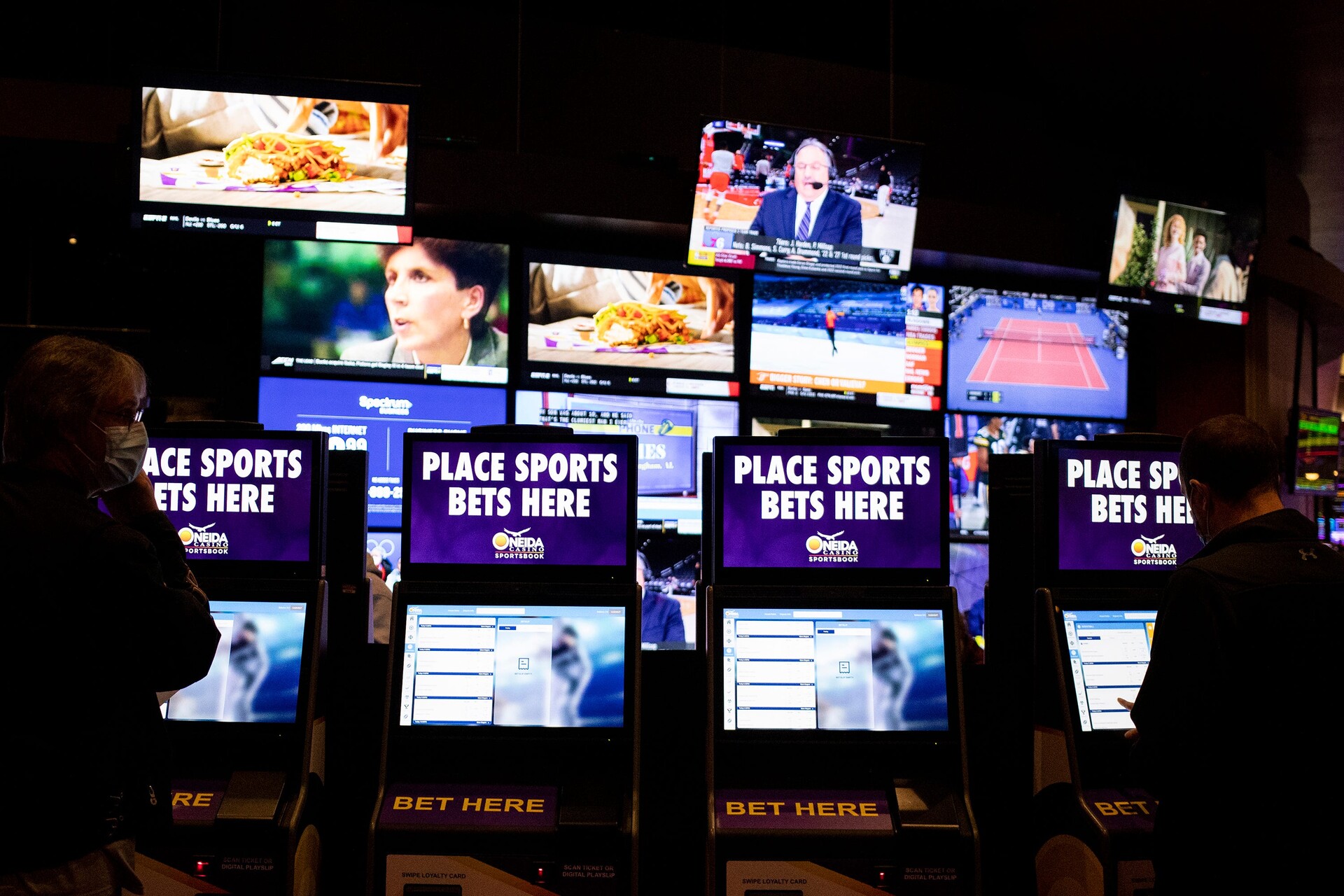 Customers place bets at a kiosks, Thursday, Feb. 10, 2022, at the Oneida Casino in Green Bay, Wis.