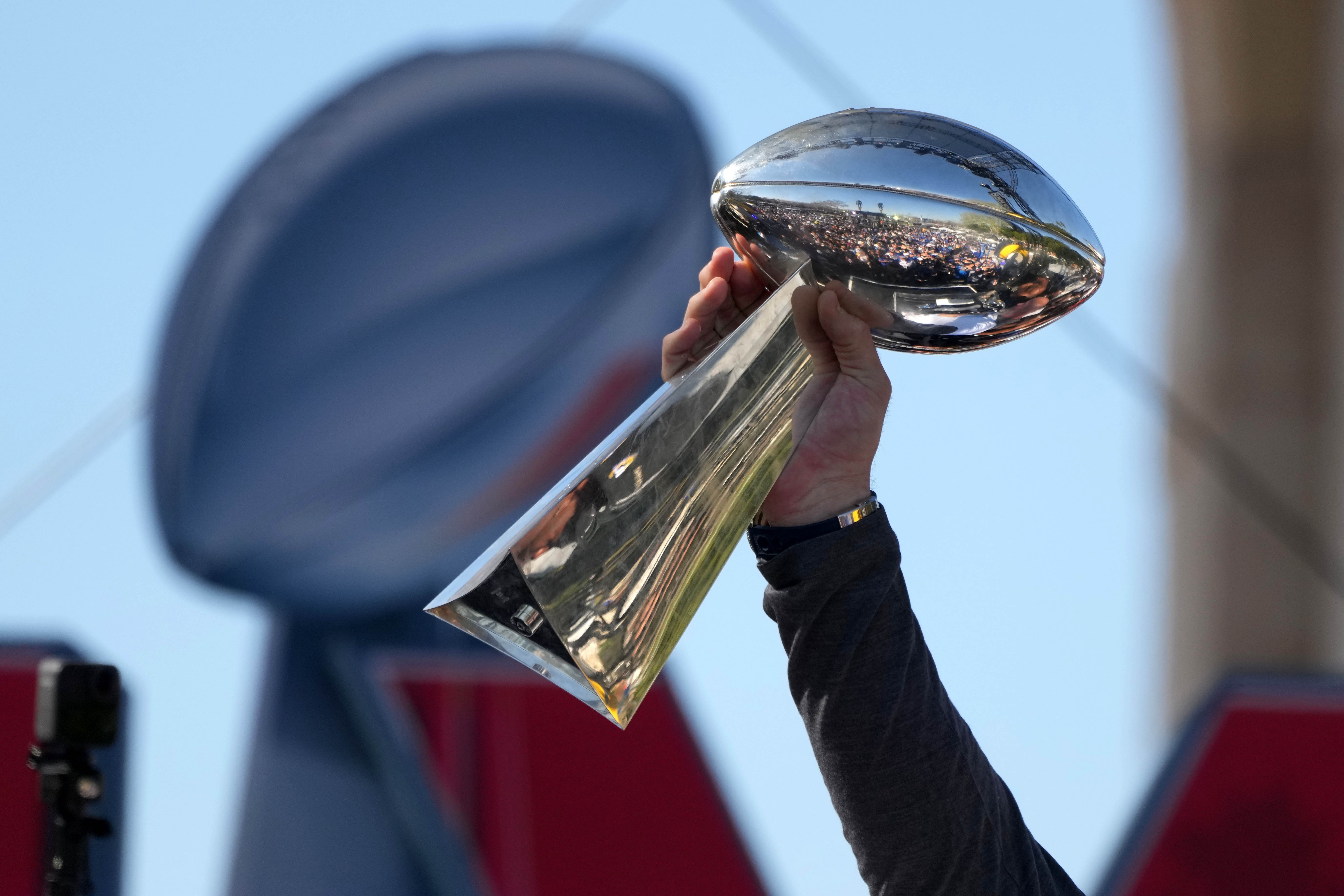 Feb 16, 2022; Los Angeles, CA, USA; Los Angeles Rams tackle Andrew Whitworth holds the Vince Lombardi trophy during the Super Bowl LVI championship rally at the Los Angeles Memorial Coliseum.