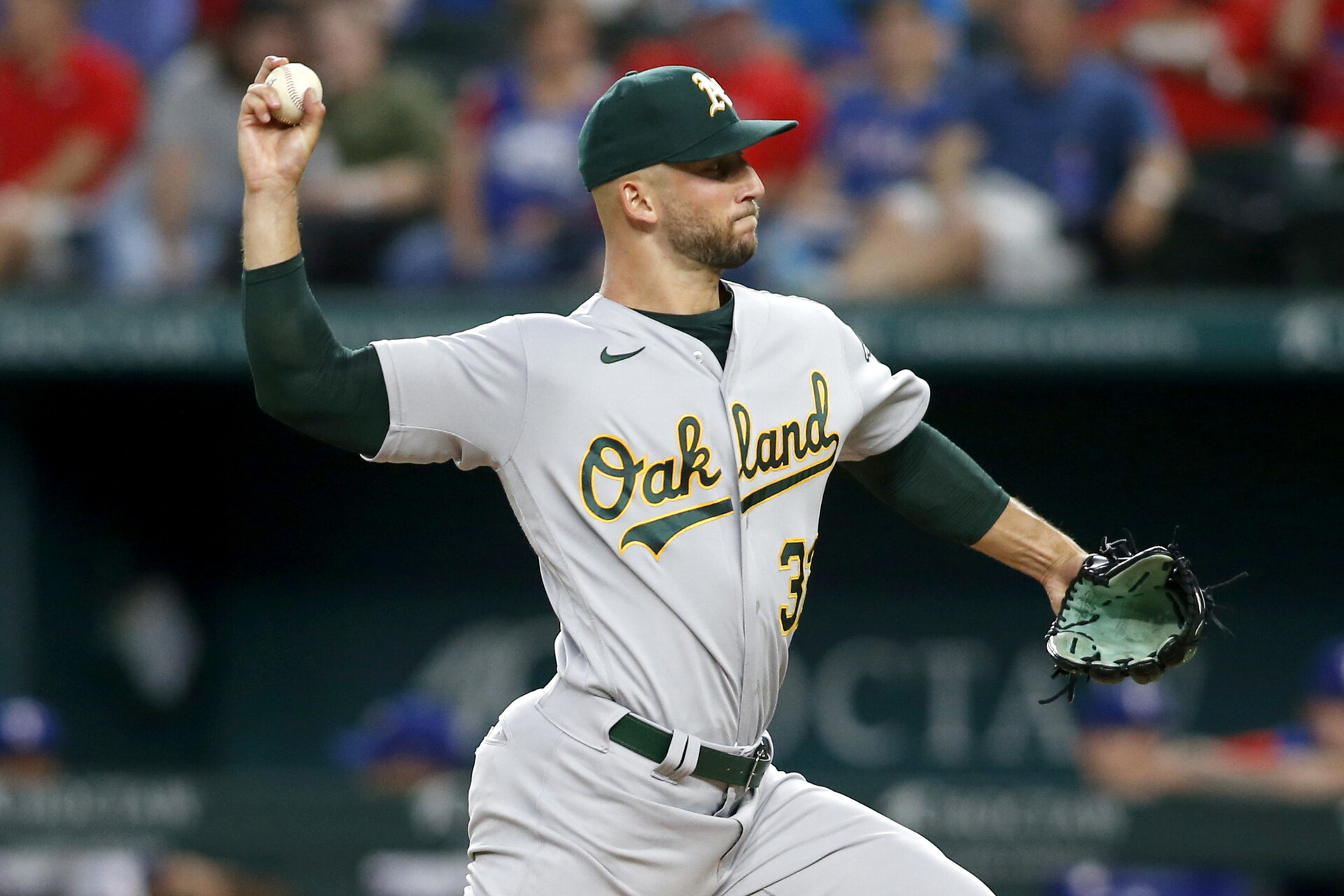 Aug 15, 2022; Arlington, Texas, USA; Oakland Athletics starting pitcher James Kaprielian (32) throws in the first inning against the Texas Rangers at Globe Life Field.
