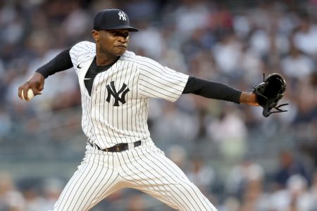 New York Yankees starting pitcher Domingo German (55) pitches against the Tampa Bay Rays during the first inning at Yankee Stadium.