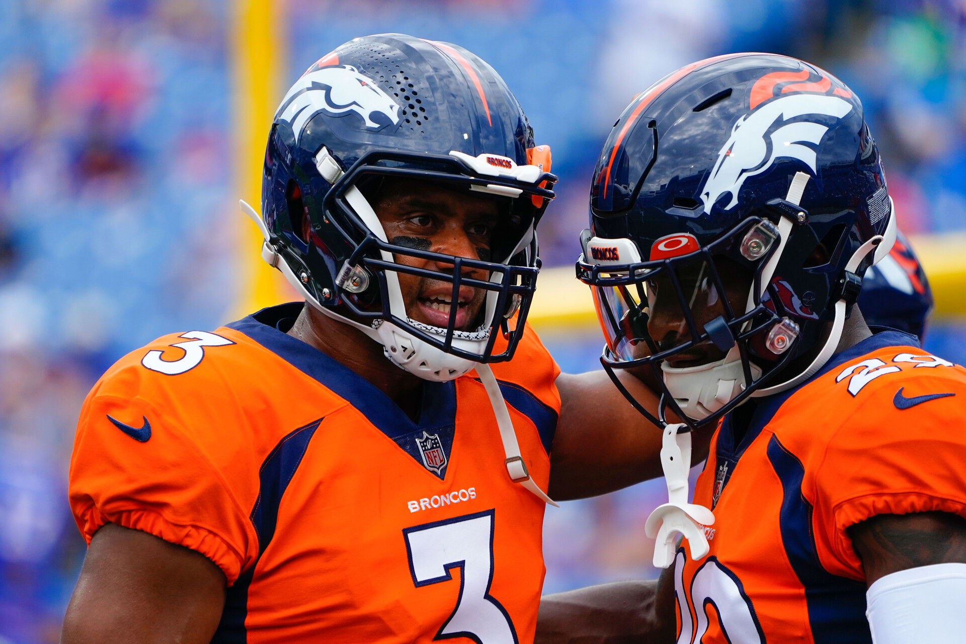 Denver Broncos quarterback Russell Wilson (3) speaks with Denver Broncos wide receiver Seth Williams (19) prior to the game against the Buffalo Bills at Highmark Stadium.