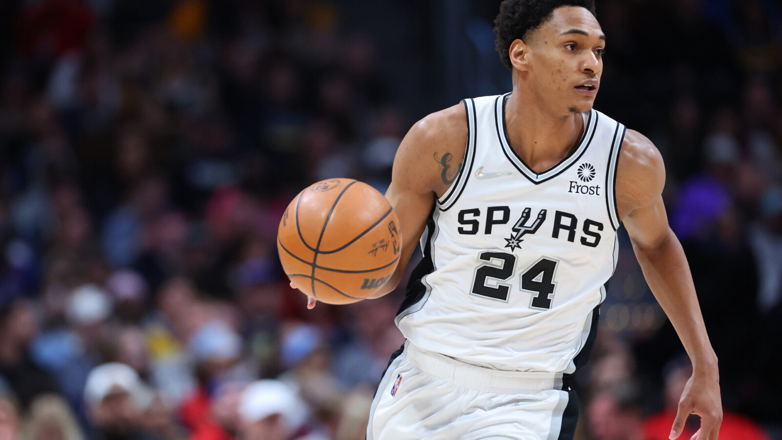 Devin Vassell #24 of the San Antonio Spurs handles the ball against the Denver Nuggets during the second quarter at Ball Arena on April 5, 2022 in Denver, Colorado.