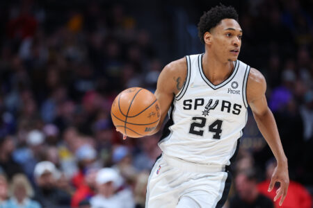 Devin Vassell #24 of the San Antonio Spurs handles the ball against the Denver Nuggets during the second quarter at Ball Arena on April 5, 2022 in Denver, Colorado.