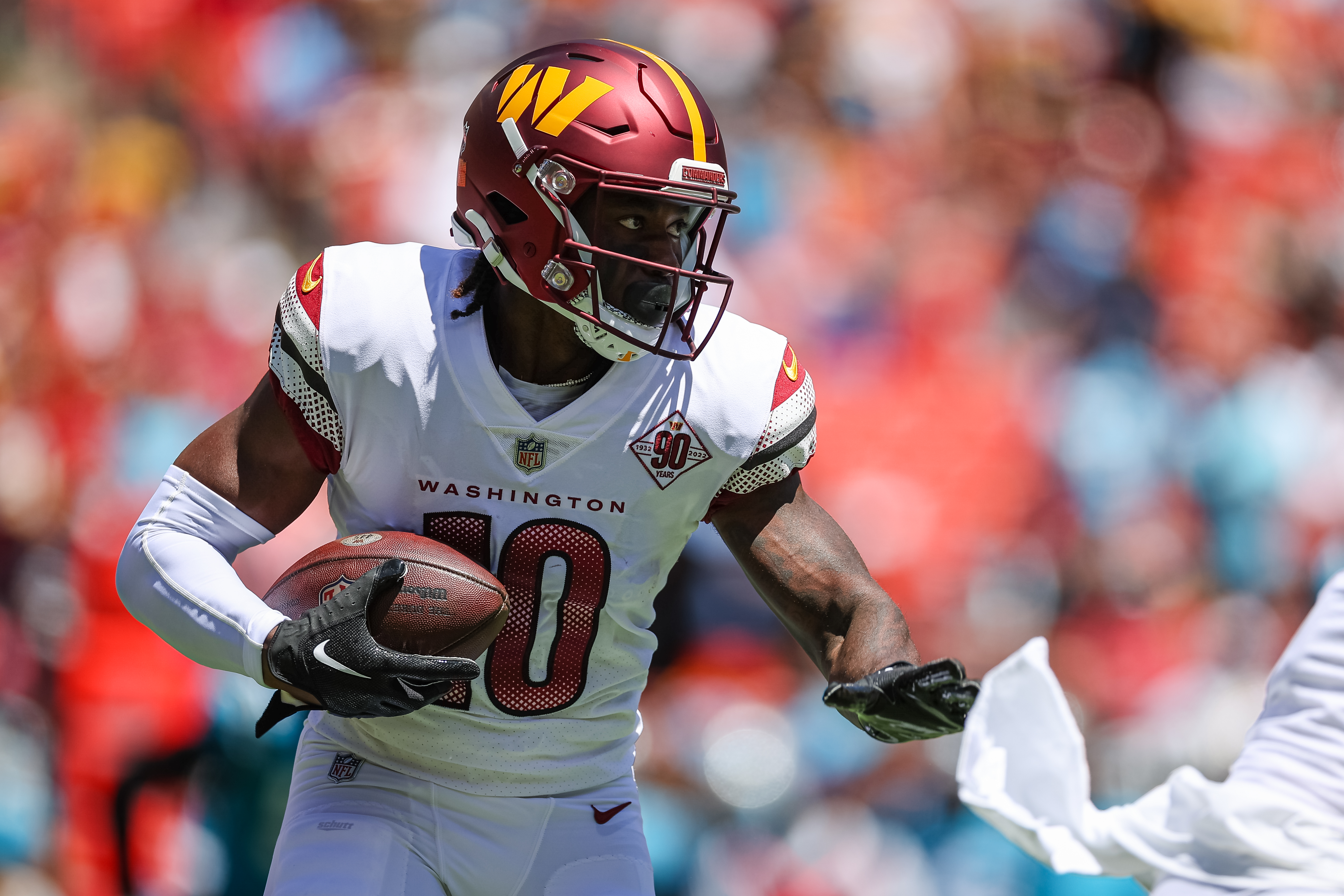 Curtis Samuel #10 of the Washington Commanders carries the ball against the Carolina Panthers during the first half of the preseason game at FedExField on August 13, 2022 in Landover, Maryland.