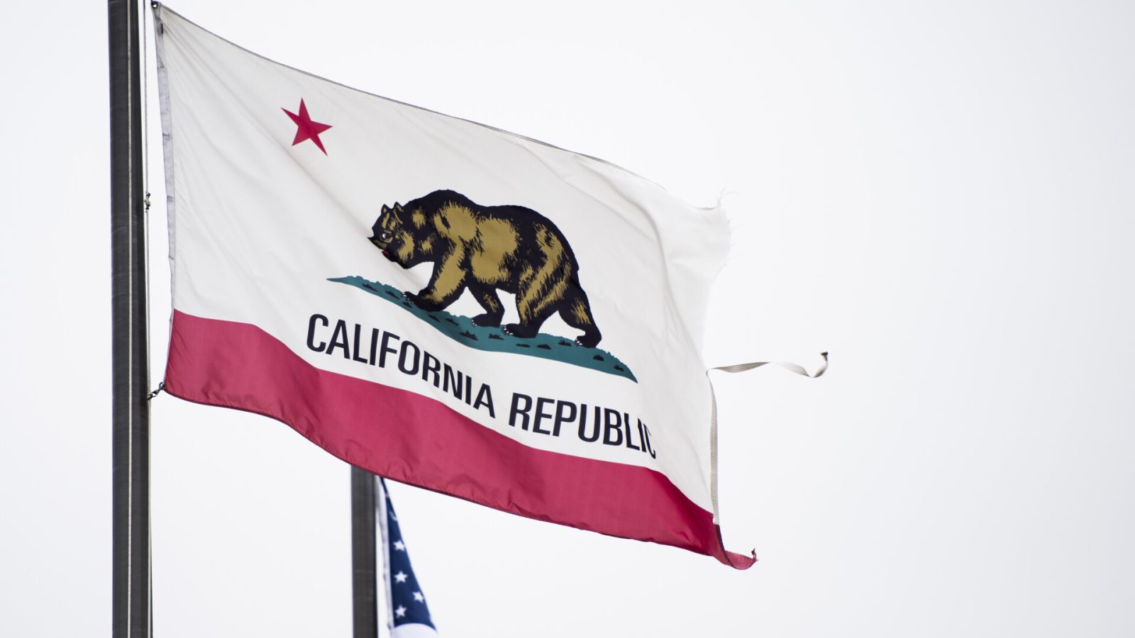 The state flag of California flies near the Los Angeles International Airport on Sunday, May 27, 2018. Negative campaign attacks between Democrats running in crucial House races have begun to tear the party apart in leading up to California's primary election on June 5, 2018.