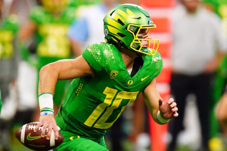 Oregon Ducks quarterback Bo Nix (10) scrambles out against the Georgia Bulldogs during the third quarter of the Chick-fil-A kickoff game at Mercedes-Benz Stadium.