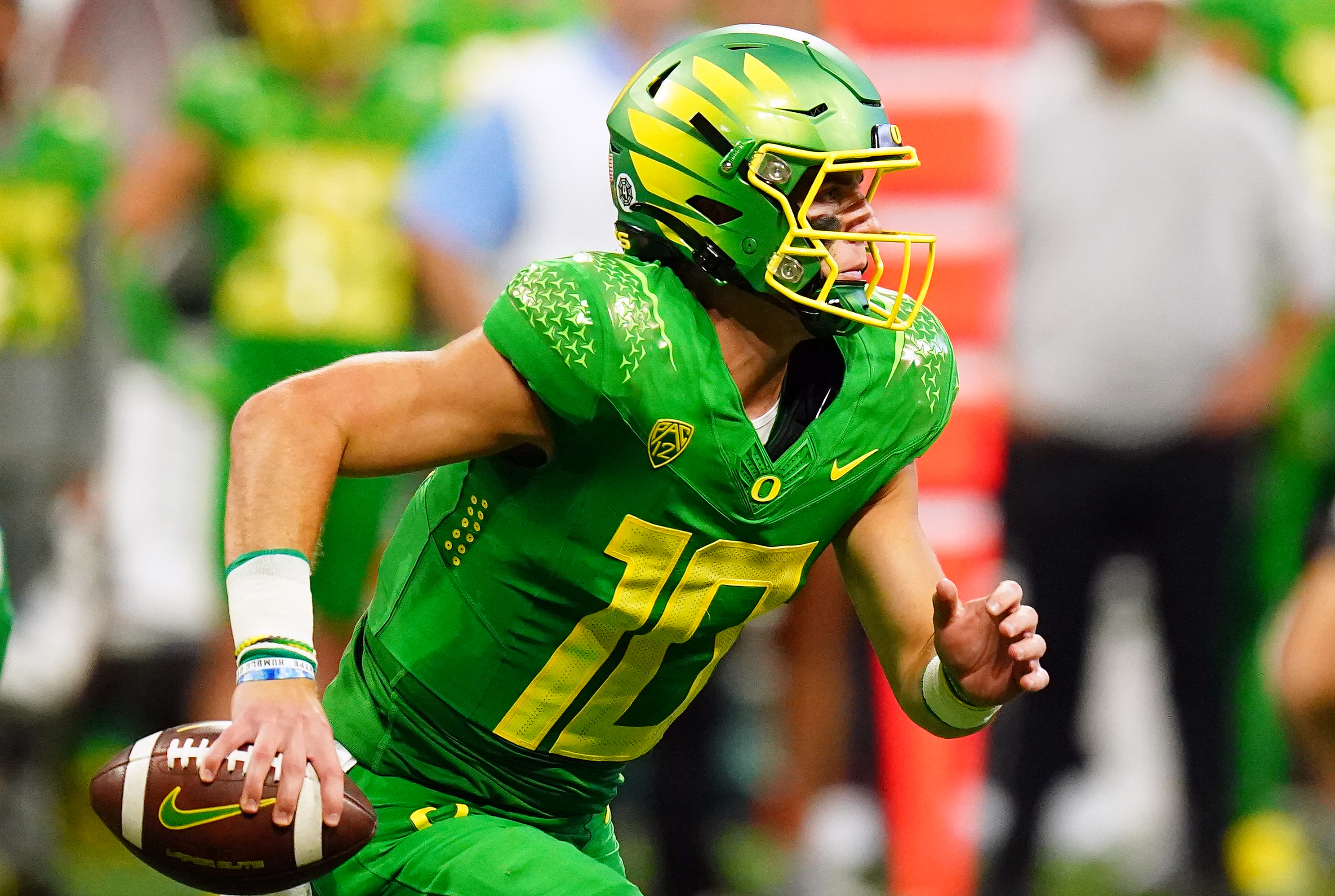 Oregon Ducks quarterback Bo Nix (10) scrambles out against the Georgia Bulldogs during the third quarter of the Chick-fil-A kickoff game at Mercedes-Benz Stadium.