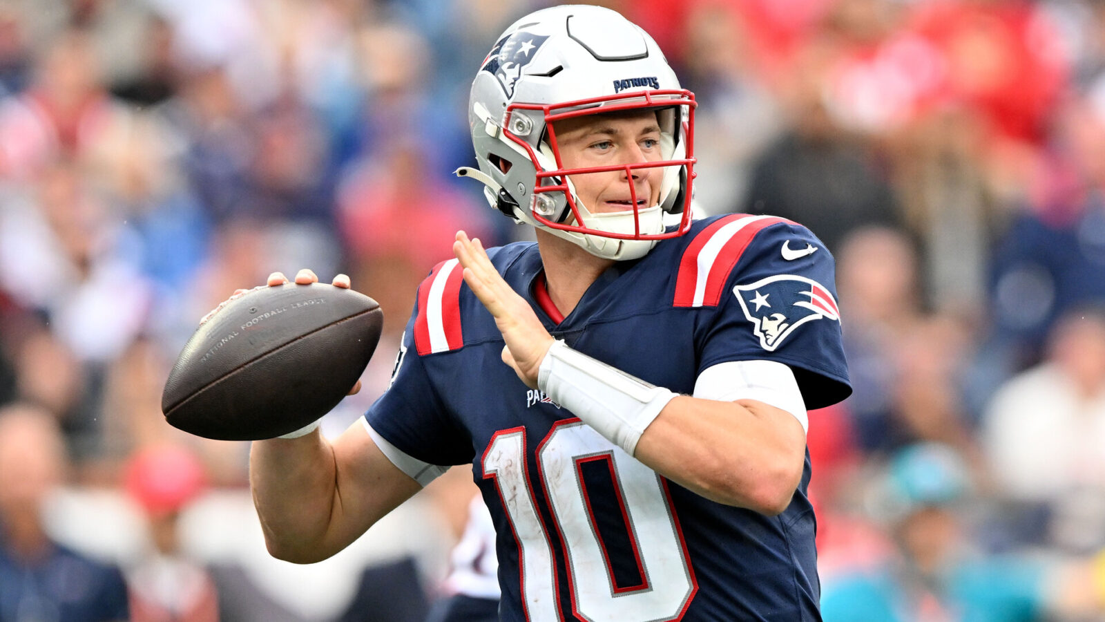 New England Patriots quarterback Mac Jones (10) throws the ball against the Baltimore Ravens during the second half at Gillette Stadium.