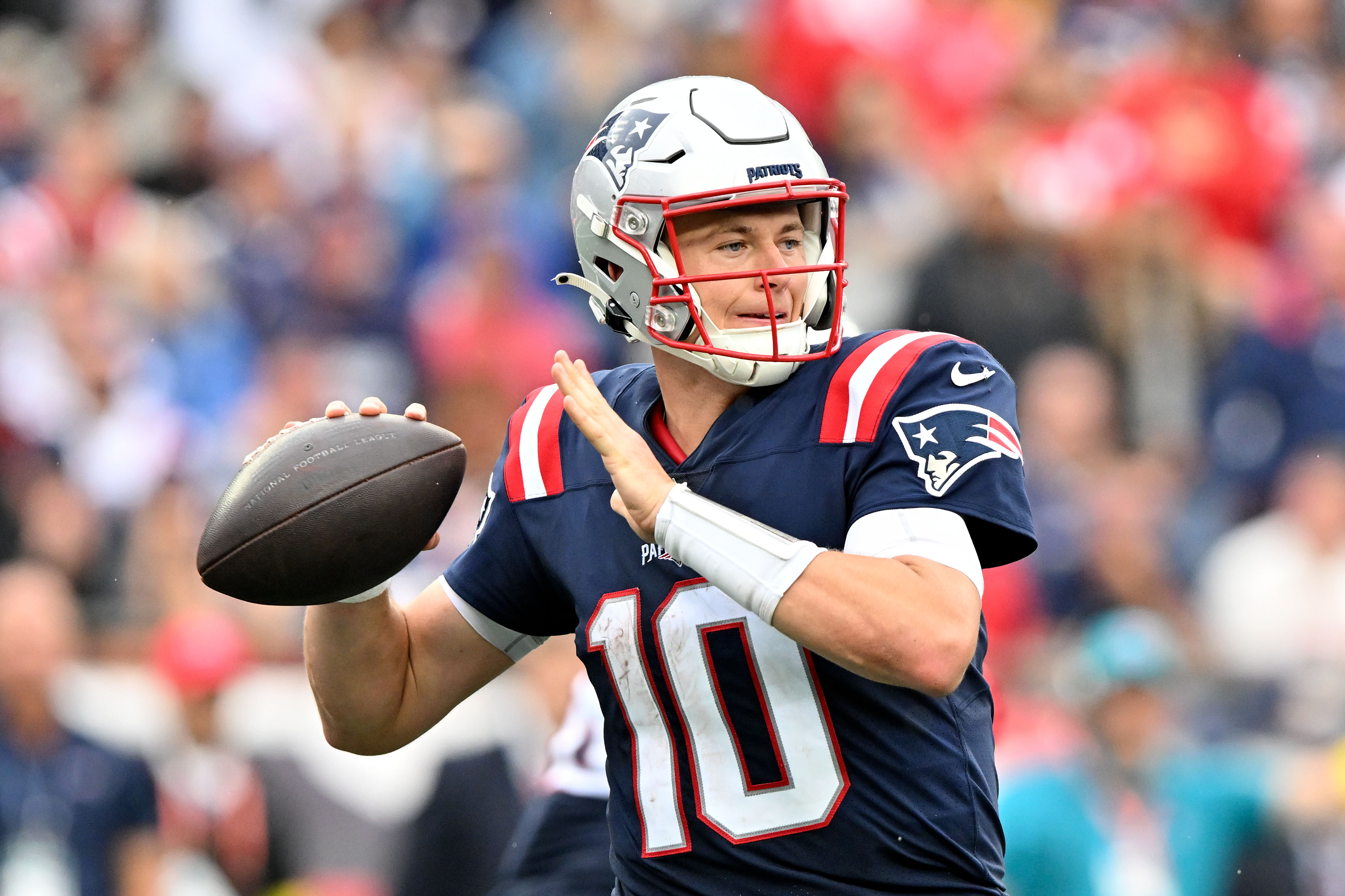 New England Patriots quarterback Mac Jones (10) throws the ball against the Baltimore Ravens during the second half at Gillette Stadium.