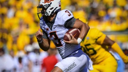 Oct 1, 2022; Waco, Texas, USA; Oklahoma State Cowboys quarterback Spencer Sanders (3) runs for a first down against the Baylor Bears during the second quarter at McLane Stadium.