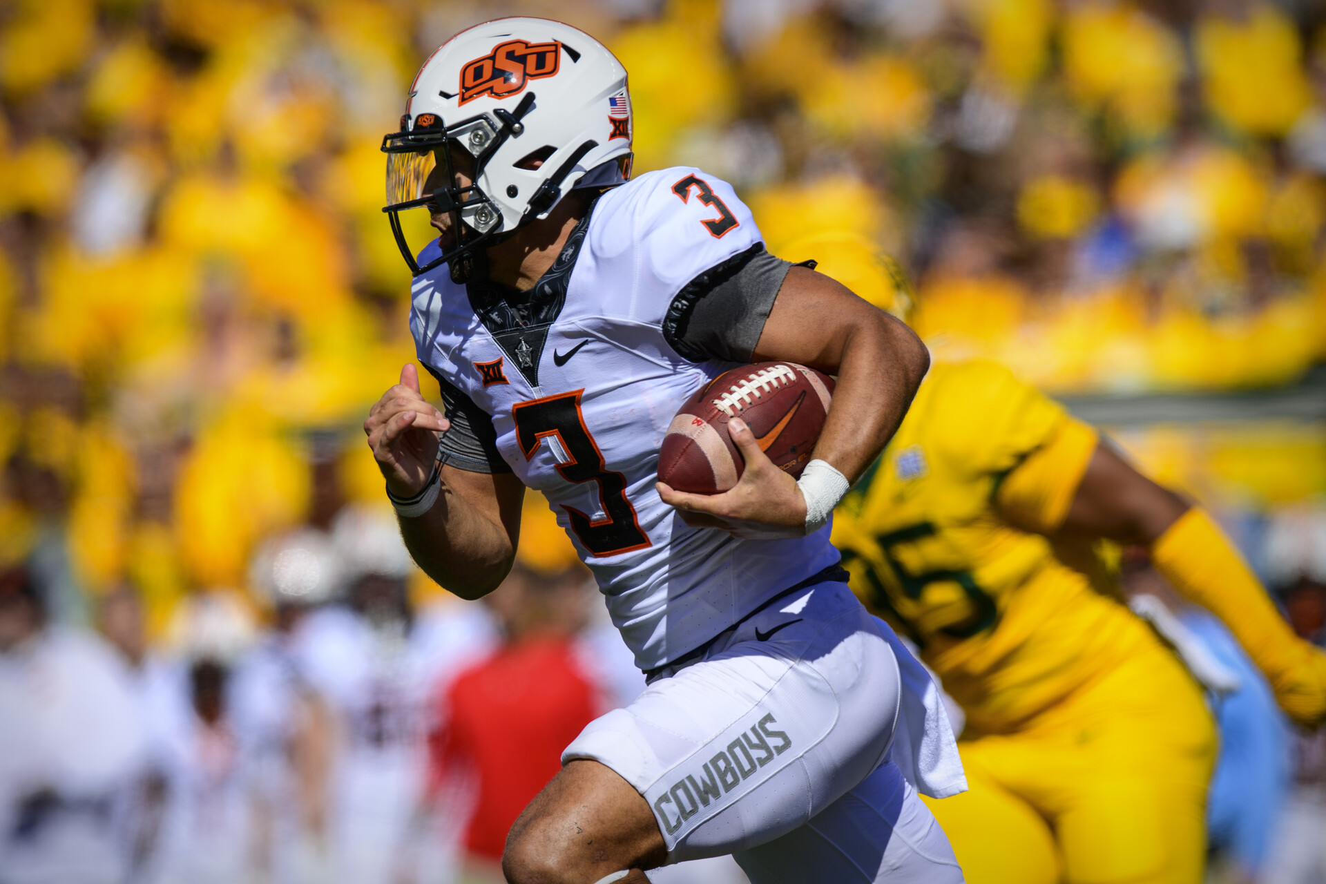 Oct 1, 2022; Waco, Texas, USA; Oklahoma State Cowboys quarterback Spencer Sanders (3) runs for a first down against the Baylor Bears during the second quarter at McLane Stadium.