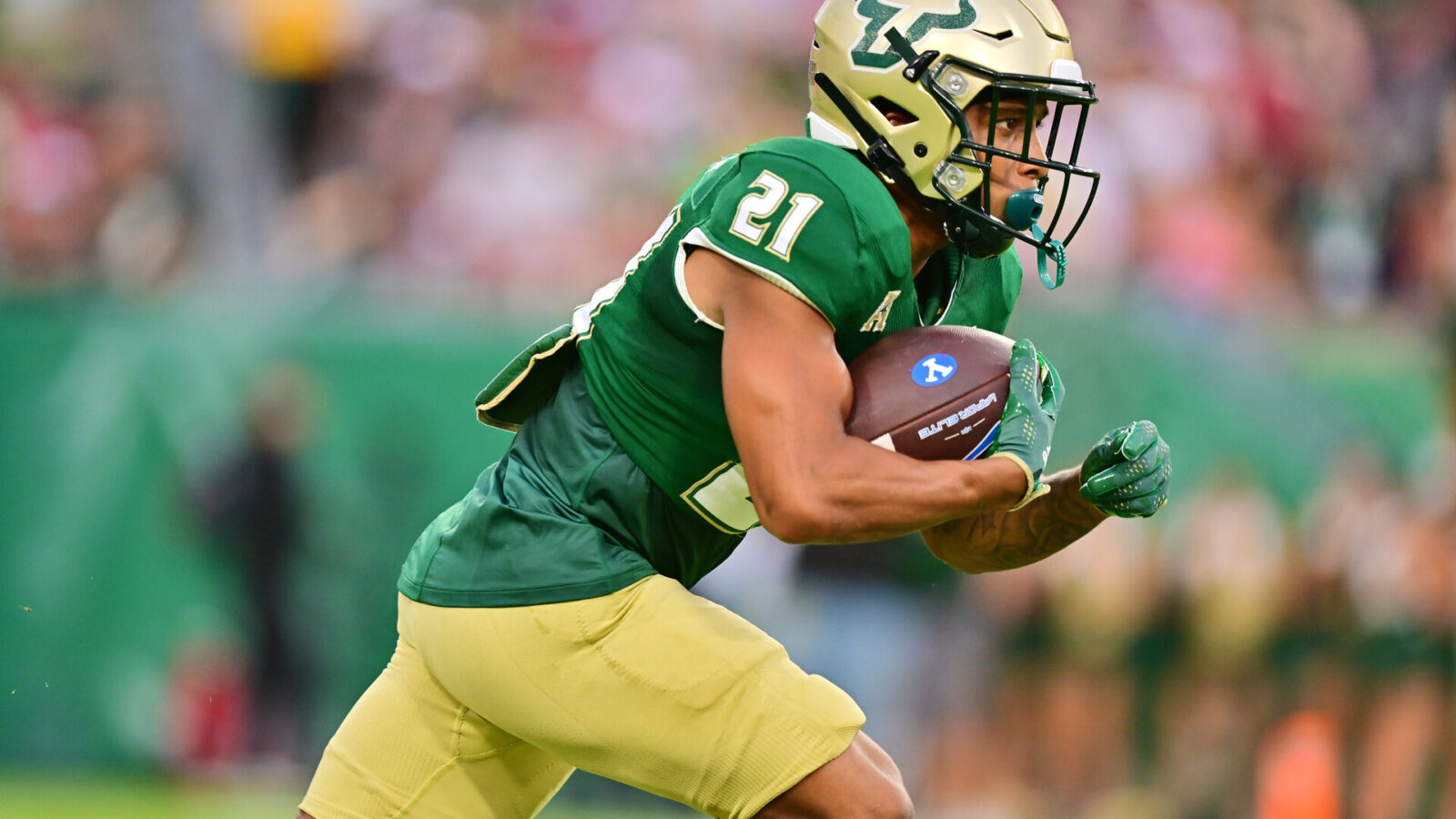 Brian Battie #21 of the South Florida Bulls runs for a 20-yard kickoff return in the first quarter against the Brigham Young Cougars at Raymond James Stadium on September 03, 2022 in Tampa, Florida.