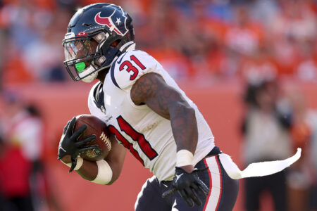Dameon Pierce #31 of the Houston Texans carries the ball against the Denver Broncos at Empower Field At Mile High on September 18, 2022 in Denver, Colorado.