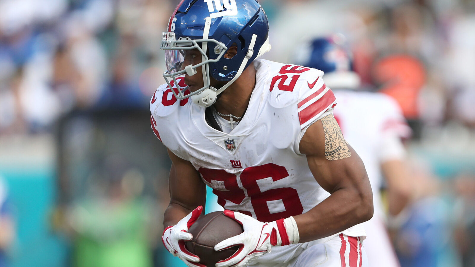 Saquon Barkley #26 of the New York Giants carries the ball during the second half against the Jacksonville Jaguars at TIAA Bank Field on October 23, 2022 in Jacksonville, Florida.