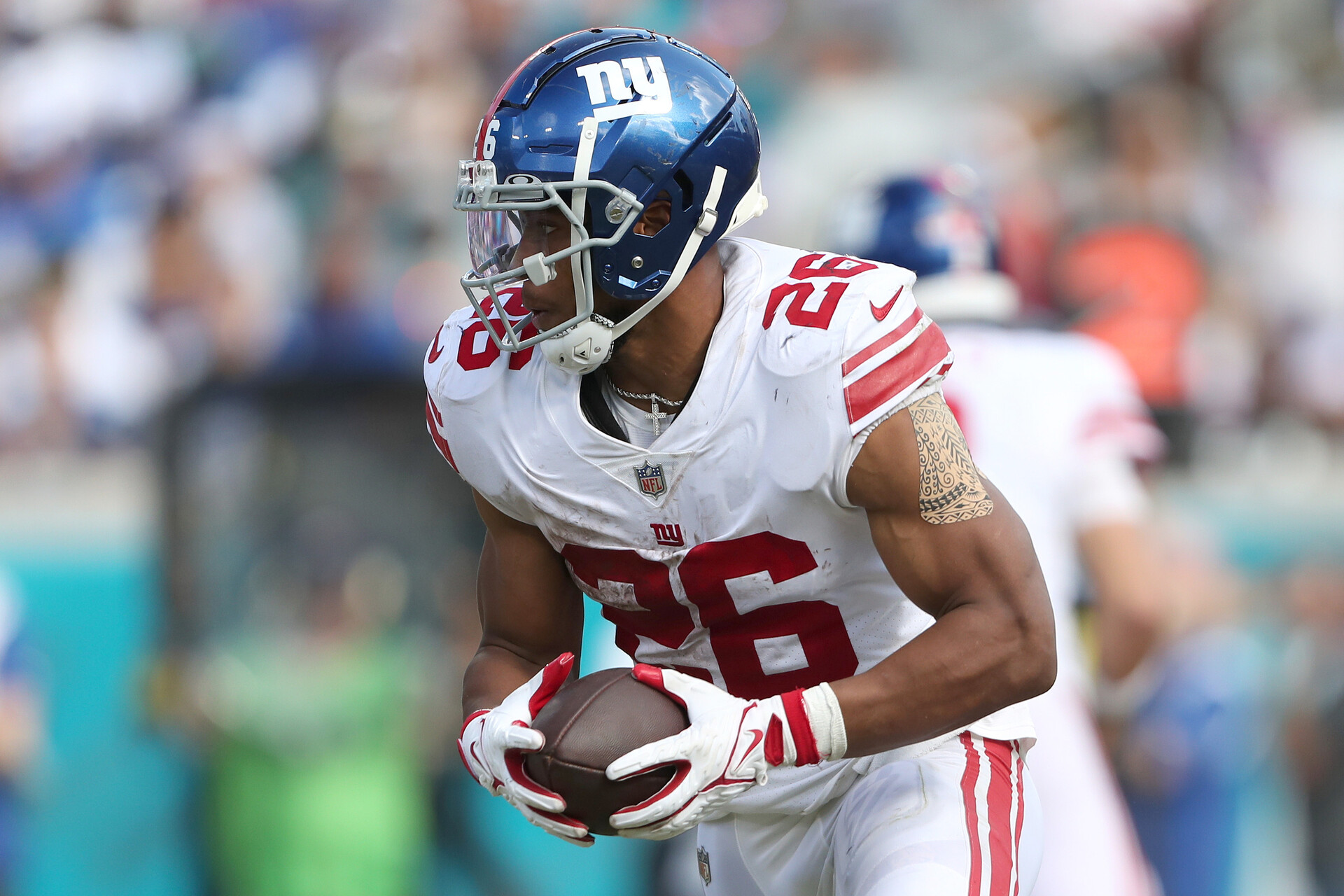Saquon Barkley #26 of the New York Giants carries the ball during the second half against the Jacksonville Jaguars at TIAA Bank Field on October 23, 2022 in Jacksonville, Florida.