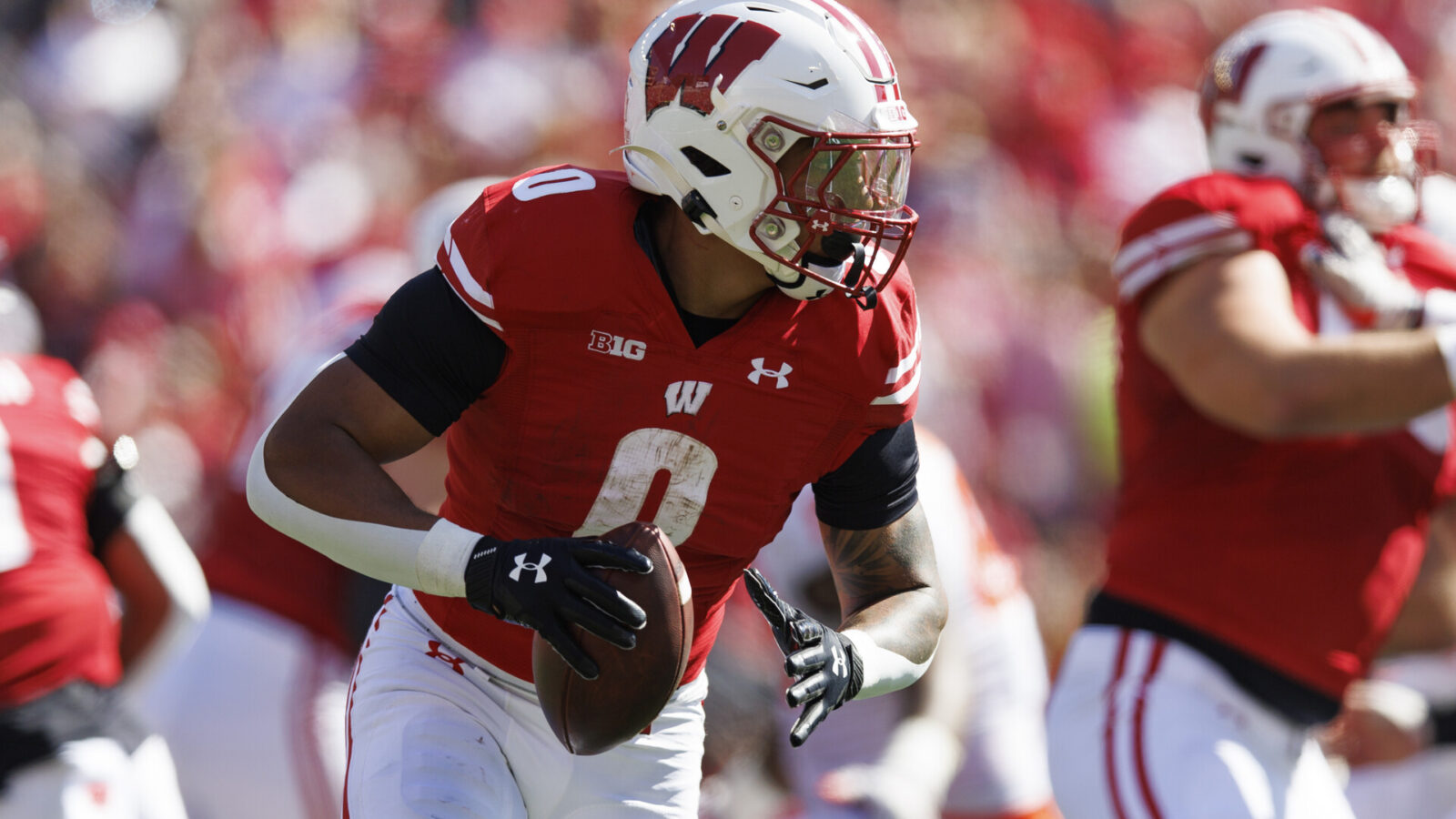 Wisconsin Badgers running back Braelon Allen (0) looks to throw a pass during the second quarter against the Illinois Fighting Illini at Camp Randall Stadium.
