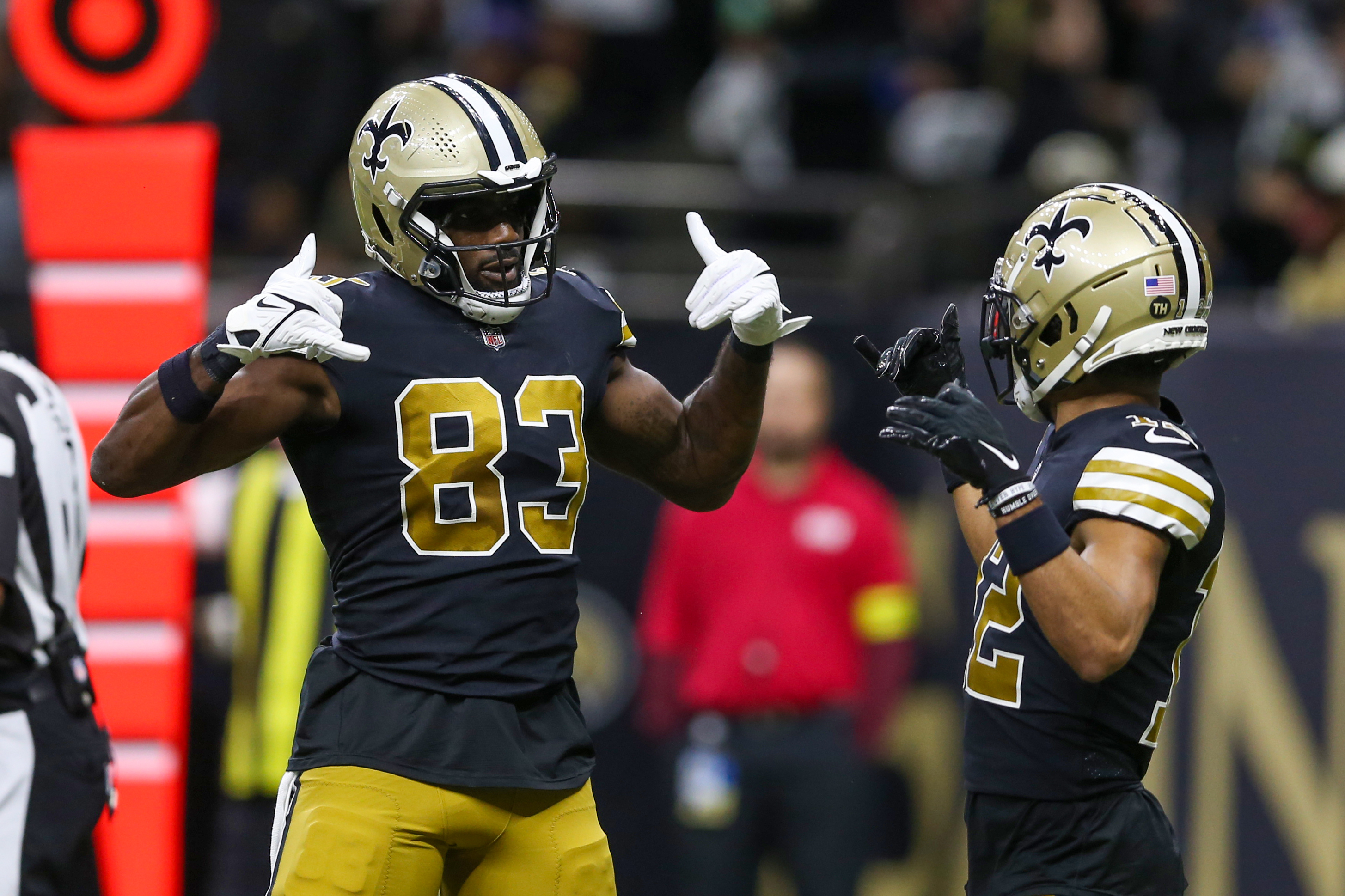 Nov 20, 2022; New Orleans, Louisiana, USA; New Orleans Saints tight end Juwan Johnson (83) celebrates his touchdown catch with wide receiver Chris Olave (12) in the second quarter against the Los Angeles Rams at the Caesars Superdome