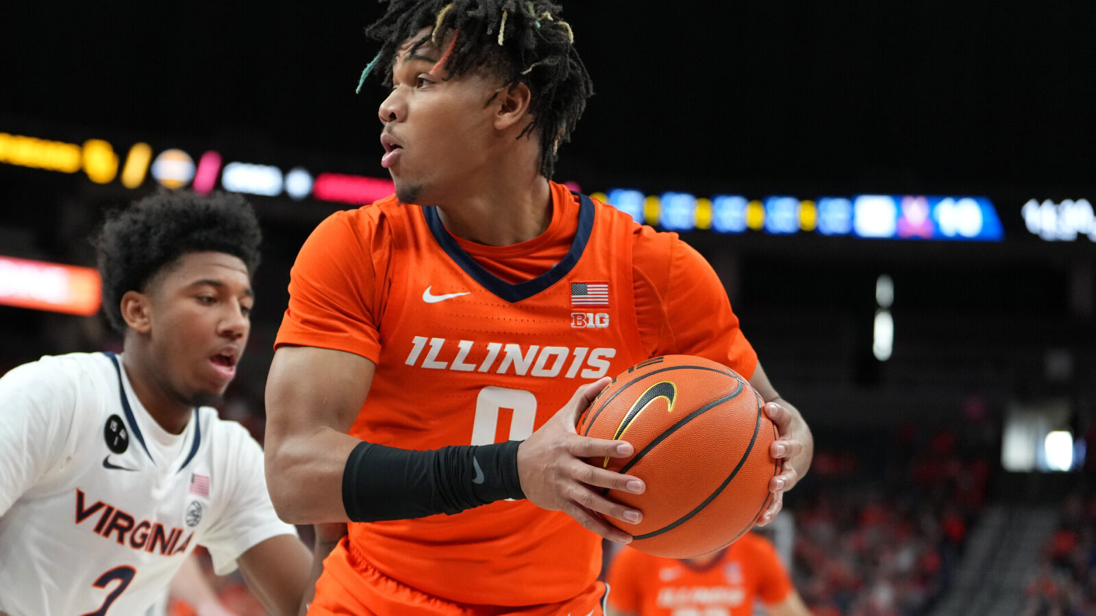 Illinois Fighting Illini guard Terrence Shannon Jr. (0) looks to pass the ball against the Virginia Cavaliers during the first half at T-Mobile Arena.