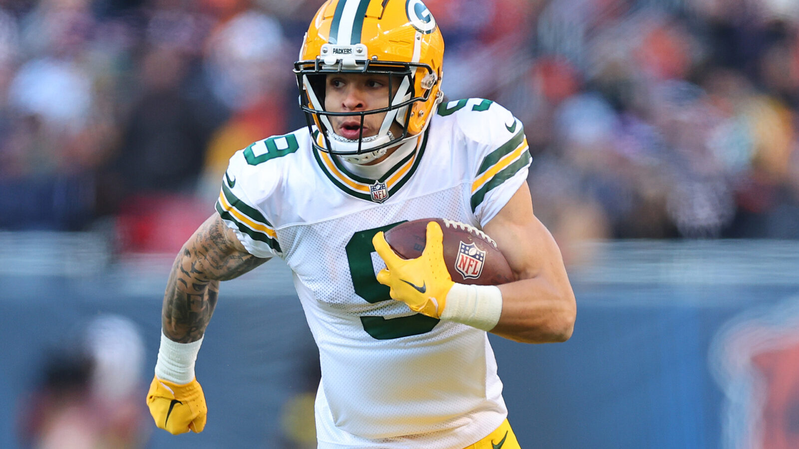 Christian Watson #9 of the Green Bay Packers runs for a touchdown against the Chicago Bears during the fourth quarter at Soldier Field on December 04, 2022 in Chicago, Illinois.