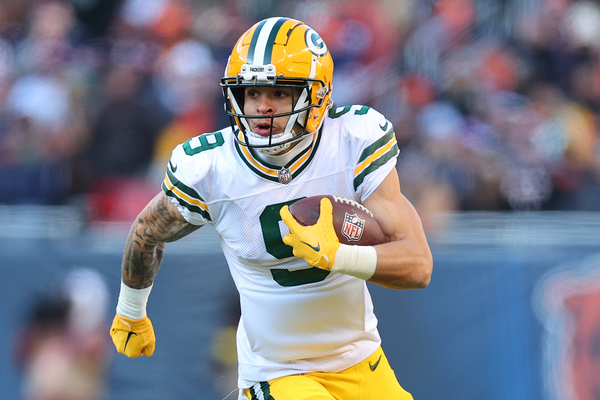 Christian Watson #9 of the Green Bay Packers runs for a touchdown against the Chicago Bears during the fourth quarter at Soldier Field on December 04, 2022 in Chicago, Illinois.