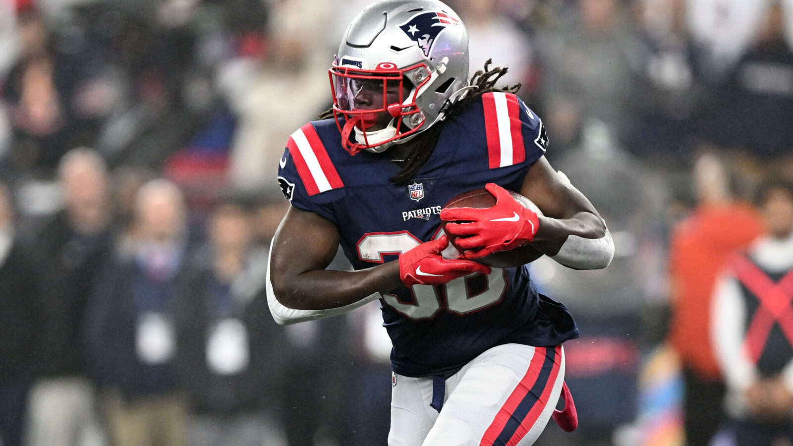 Foxborough, Massachusetts, USA; New England Patriots running back Rhamondre Stevenson (38) runs with the ball against the Chicago Bears during the first half at Gillette Stadium.