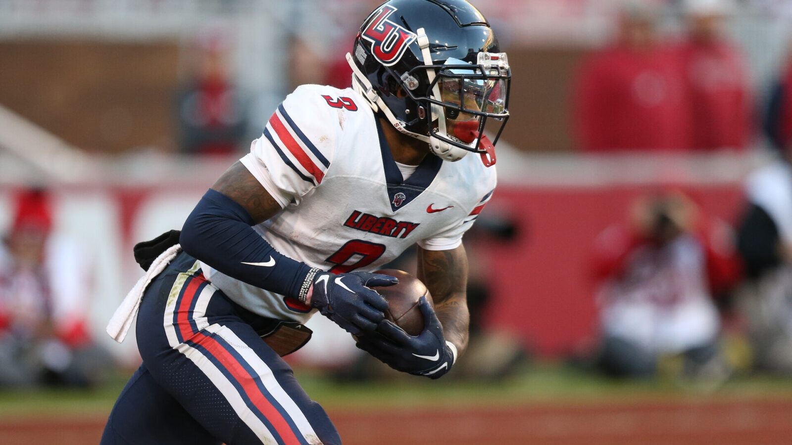 Liberty Flames wide receiver Demario Douglas (3) returns a kick during the second half against the Arkansas Razorbacks at Donald W. Reynolds Razorback Stadium.