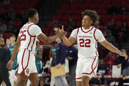 Oklahoma guard C.J. Noland (22) celebrates with Oklahoma guard Grant Sherfield (25) following a basket against NC Wilmington during the first half at Lloyd Noble Center.