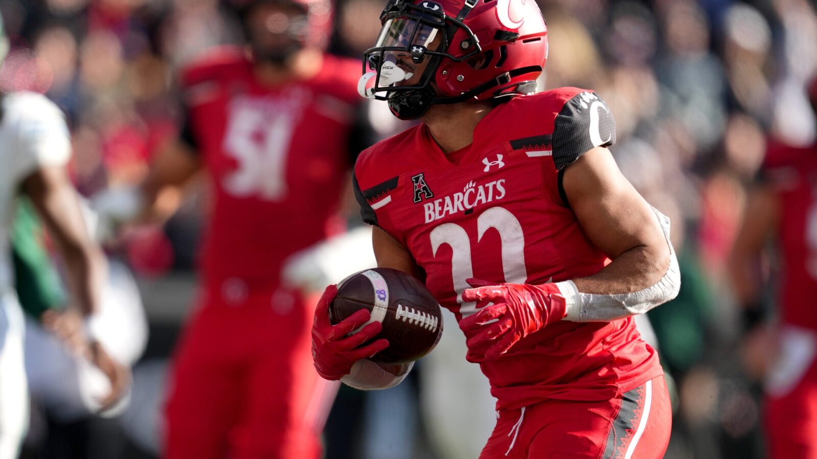 Cincinnati Bearcats running back Ryan Montgomery (22) runs for a touchdown in the third quarter during a college football game against the Tulane Green Wave, Friday, Nov. 25, 2022, at Nippert Stadium in Cincinnati.