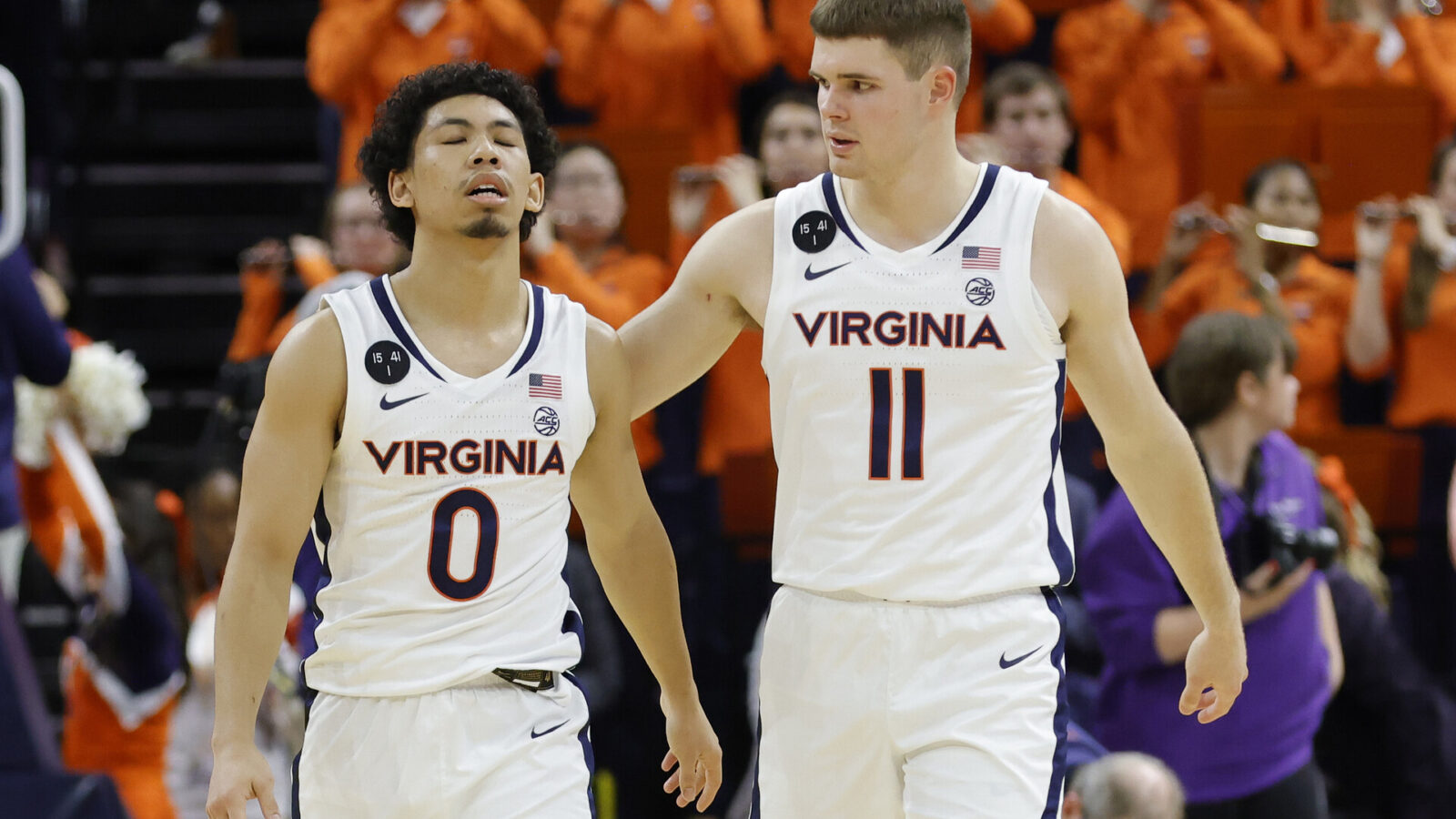 Virginia Cavaliers guard Kihei Clark (0) reacts with Cavaliers guard Isaac McKneely (11) after their game against the James Madison Dukes at John Paul Jones Arena.