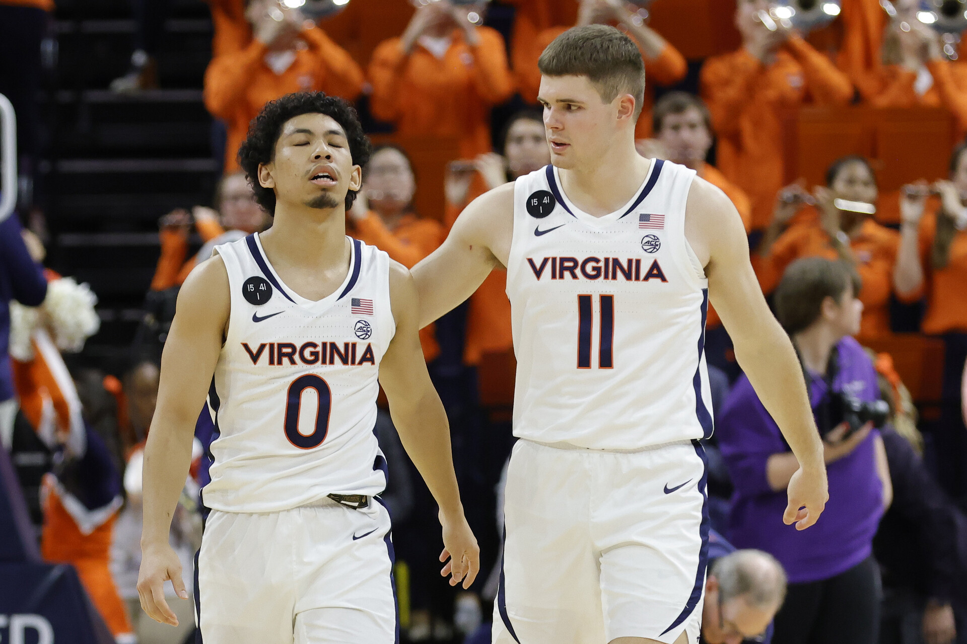 Virginia Cavaliers guard Kihei Clark (0) reacts with Cavaliers guard Isaac McKneely (11) after their game against the James Madison Dukes at John Paul Jones Arena.