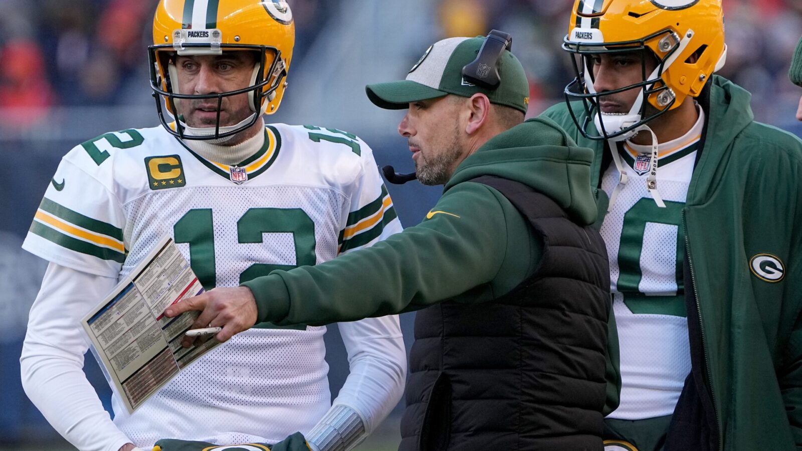 Green Bay Packers quarterback Aaron Rodgers (12) and quarterback Jordan Love (10) listen to head coach Matt LaFleur during the fourth quarter of their game Sunday, December 4, 2022 at Soldier Field in Chicago, Ill. The Green Bay Packers beat the Chicago Bears 28-19.