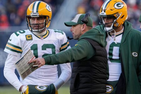 Green Bay Packers quarterback Aaron Rodgers (12) and quarterback Jordan Love (10) listen to head coach Matt LaFleur during the fourth quarter of their game Sunday, December 4, 2022 at Soldier Field in Chicago, Ill. The Green Bay Packers beat the Chicago Bears 28-19.