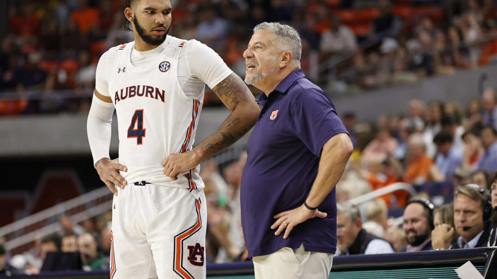 Auburn Tigers forward Johni Broome (4) talks with head coach Bruce Pearl during the second half against the George Mason Patriots at Neville Arena.