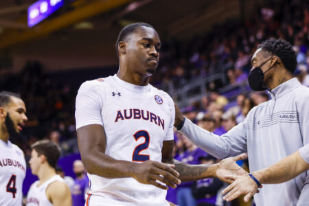 Auburn Tigers forward Jaylin Williams (2) greets teammates and staff on the bench following a late second half substitution against the Washington Huskies at Alaska Airlines Arena at Hec Edmundson Pavilion.