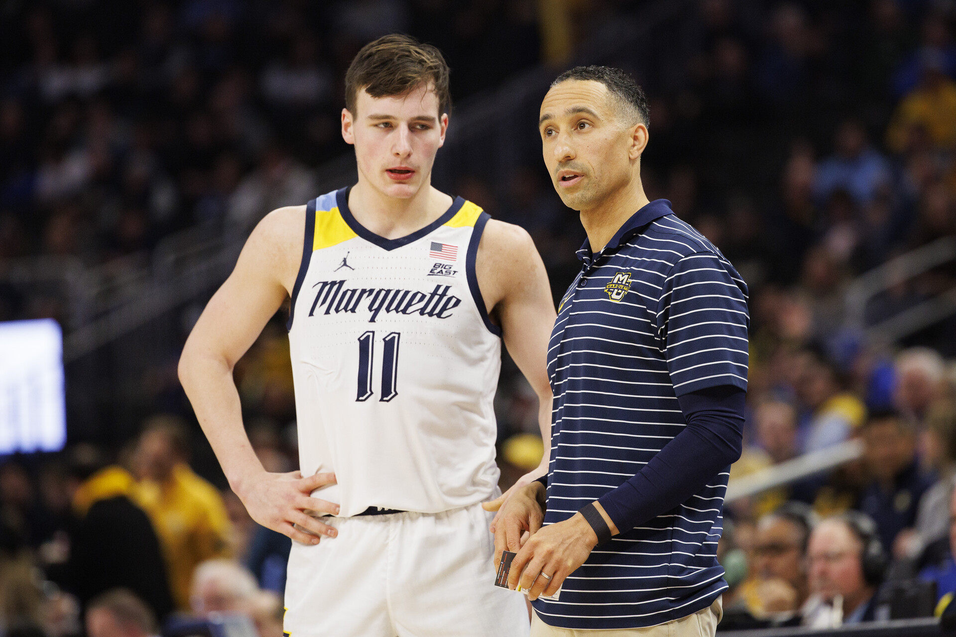 Marquette Golden Eagles head coach Shaka Smart talks with guard Tyler Kolek (11) during the game against the Creighton Bluejays at Fiserv Forum.