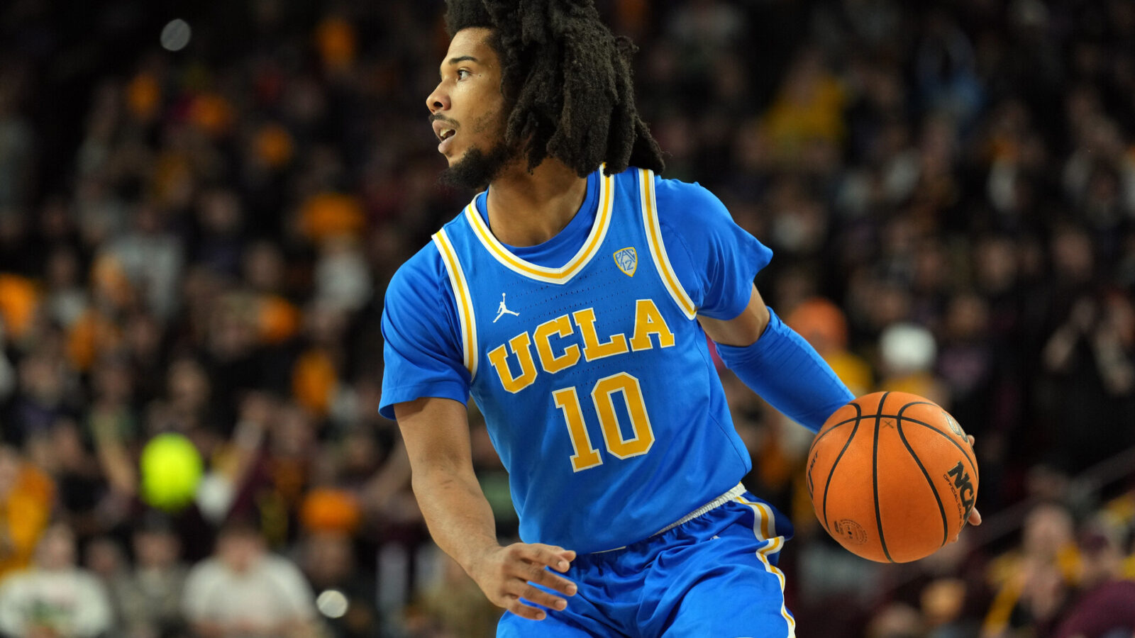 UCLA Bruins guard Tyger Campbell (10) dribbles against the Arizona State Sun Devils during the first half at Desert Financial Arena.