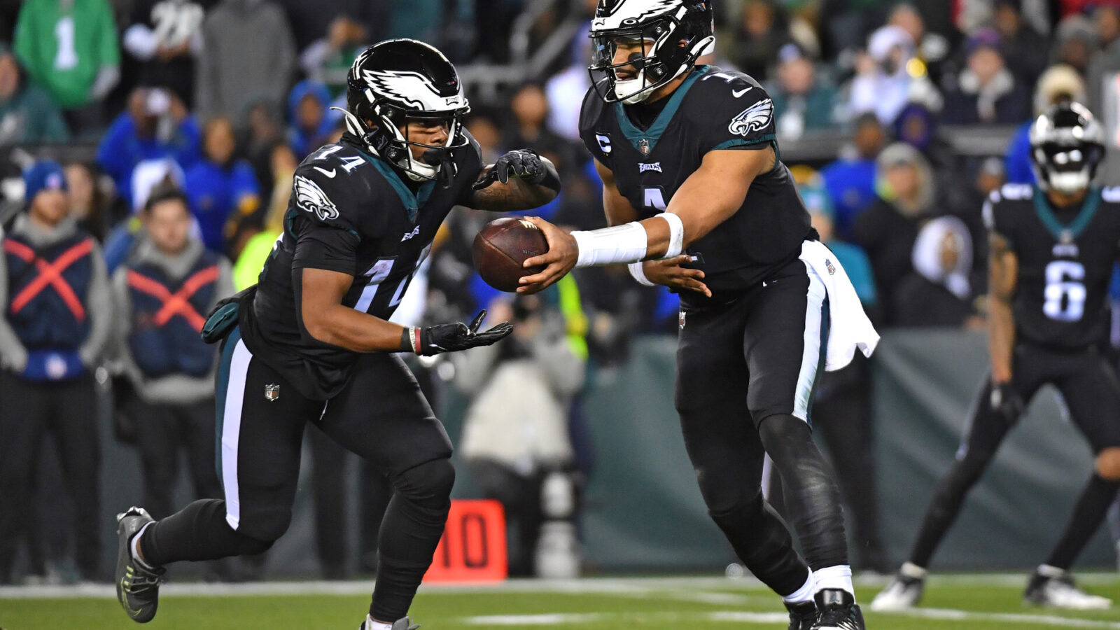 Jan 8, 2023; Philadelphia, Pennsylvania, USA; Philadelphia Eagles quarterback Jalen Hurts (1) hands the ball off to running back Kenneth Gainwell (14) against the New York Giants during the fourth quarter at Lincoln Financial Field.