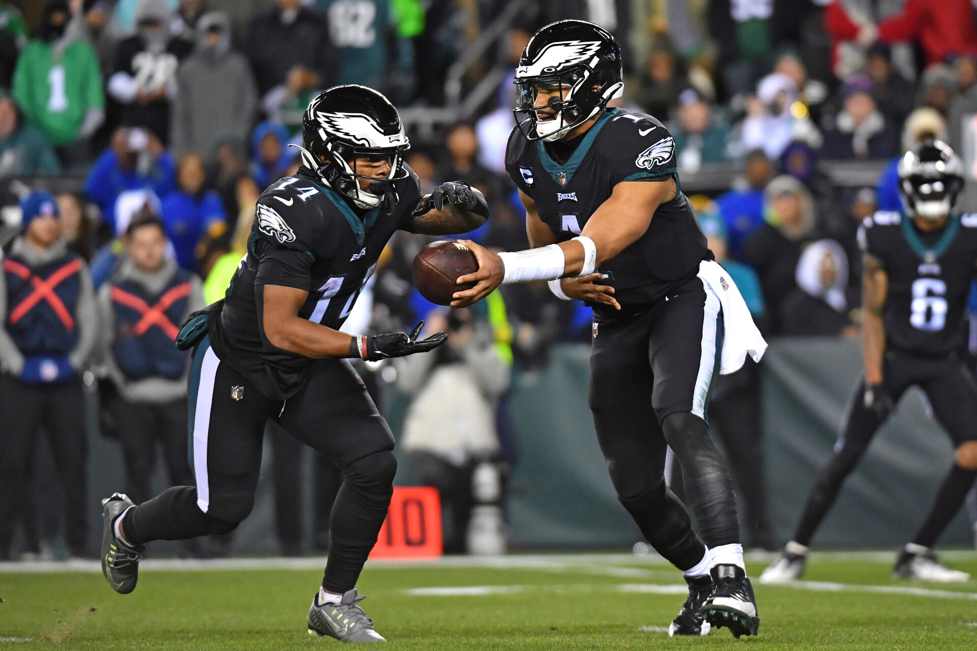 Jan 8, 2023; Philadelphia, Pennsylvania, USA; Philadelphia Eagles quarterback Jalen Hurts (1) hands the ball off to running back Kenneth Gainwell (14) against the New York Giants during the fourth quarter at Lincoln Financial Field.