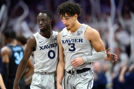 Xavier Musketeers guard Souley Boum (0) and Xavier Musketeers guard Colby Jones (3) walk back to the bench during a timeout in the second half of a college basketball game between the Villanova Wildcats and the Xavier Musketeers, Tuesday, Feb. 21, 2023, at Cintas Center in Cincinnati. The Villanova Wildcats won, 64-63.