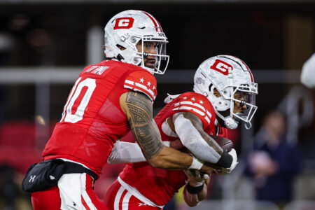 Jordan Ta'amu #10 of the DC Defenders hands the ball off to Abram Smith #4 during the first half of the XFL game against the Seattle Sea Dragons at Audi Field on February 19, 2023 in Washington, DC.
