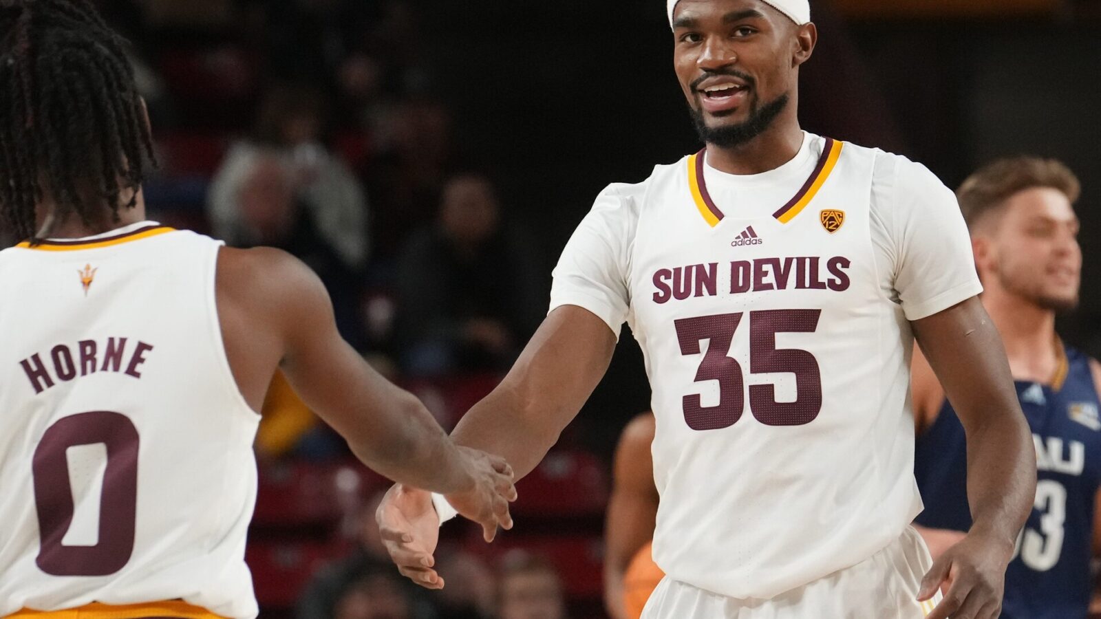 ASU Sun Devils guard Devan Cambridge (35) high-fives teammate DJ Horne (0) during their 84-68 win over the NAU Lumberjacks at Desert Financial Arena.