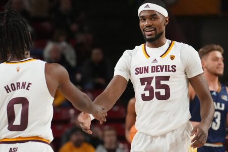 ASU Sun Devils guard Devan Cambridge (35) high-fives teammate DJ Horne (0) during their 84-68 win over the NAU Lumberjacks at Desert Financial Arena.