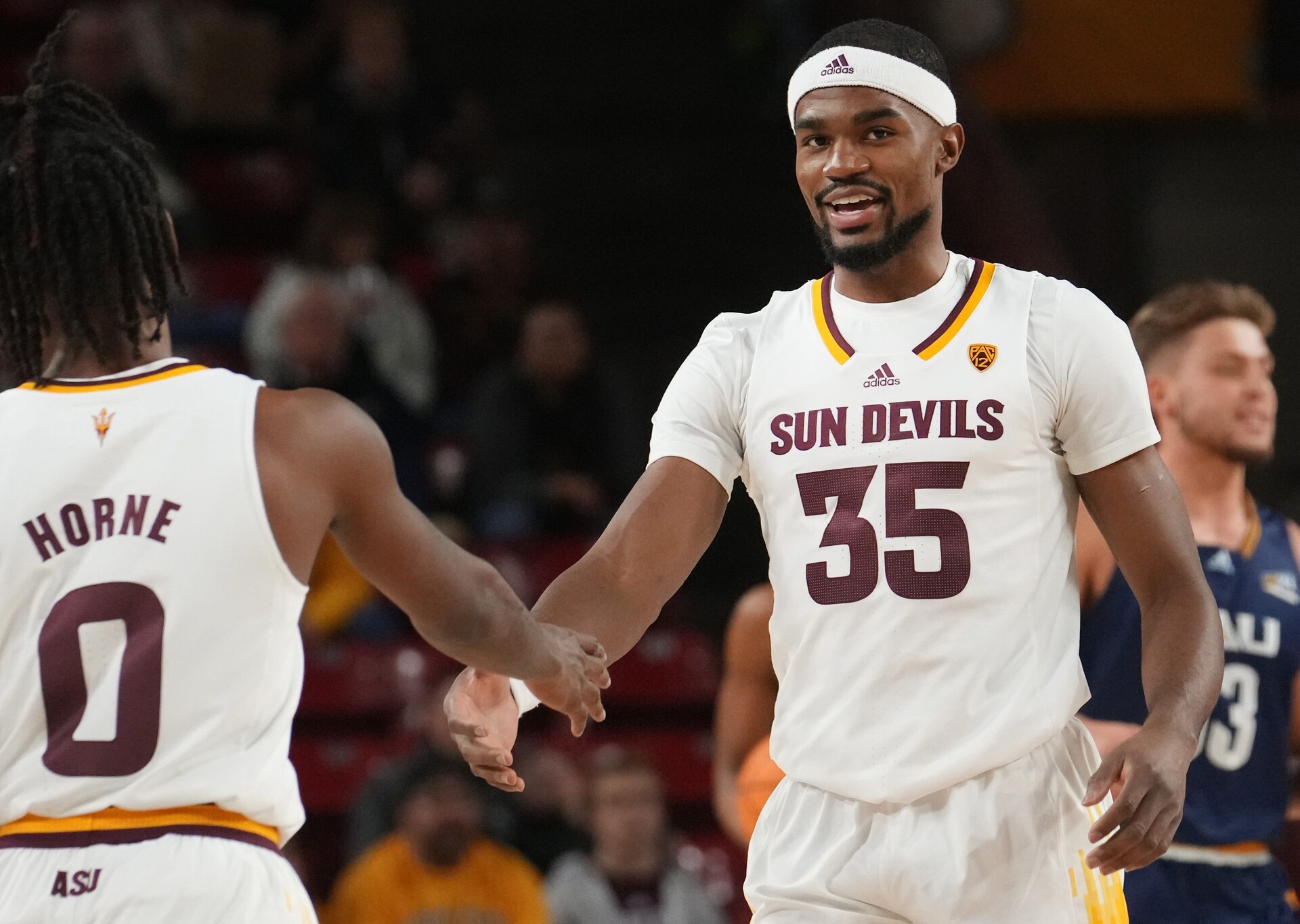 ASU Sun Devils guard Devan Cambridge (35) high-fives teammate DJ Horne (0) during their 84-68 win over the NAU Lumberjacks at Desert Financial Arena.