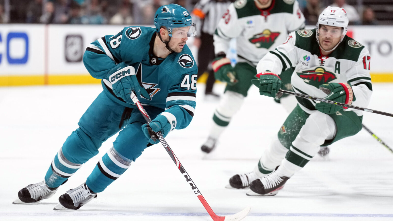 Mar 11, 2023; San Jose, California, USA; San Jose Sharks center Tomas Hertl (48) skates with the puck against Minnesota Wild left wing Marcus Foligno (17) during the second period at SAP Center at San Jose.